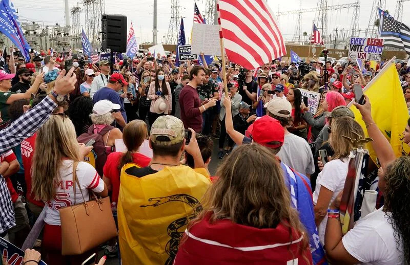 Charlie Kirk, center, conservative activist and founder of Turning Point USA, speaks to supporters of President Donald Trump at a rally outside the Maricopa County Recorder's Office, Friday, Nov. 6, 2020, in Phoenix. | Ross D. Franklin, Associated Press