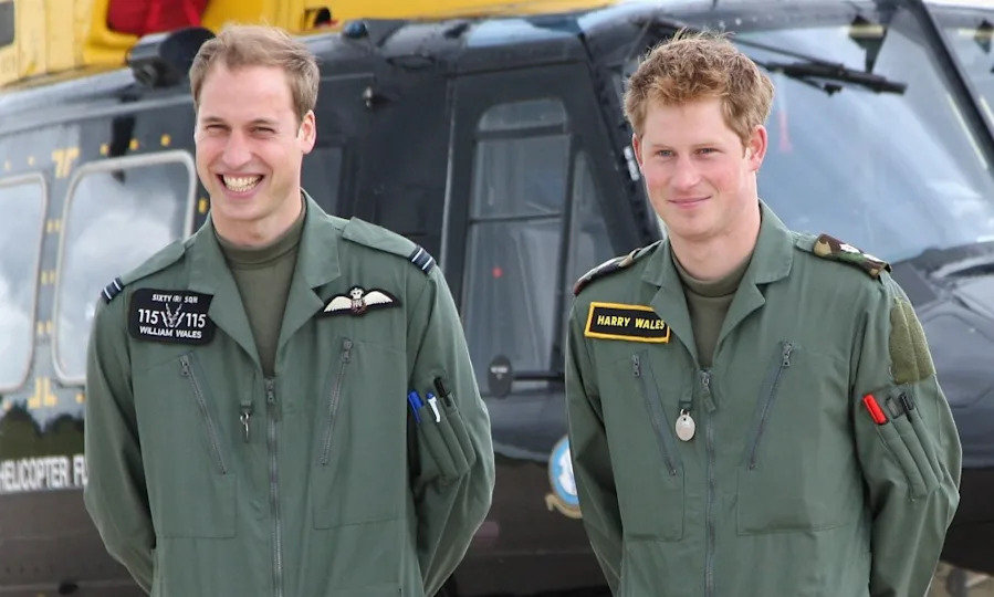 Prince William and Prince Harry pose in front of a Griffin helicopter during a photocall at RAF Shawbury on June 18, 2009. Getty Images