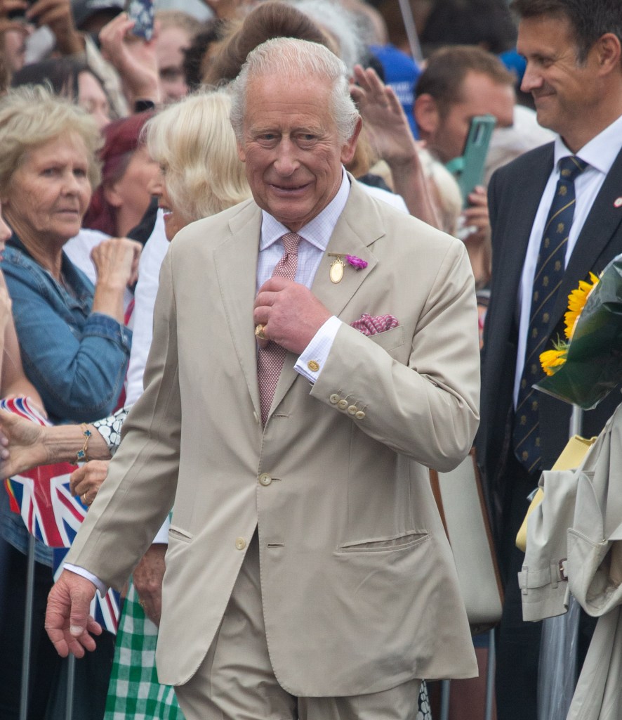 King Charles walking in suit
