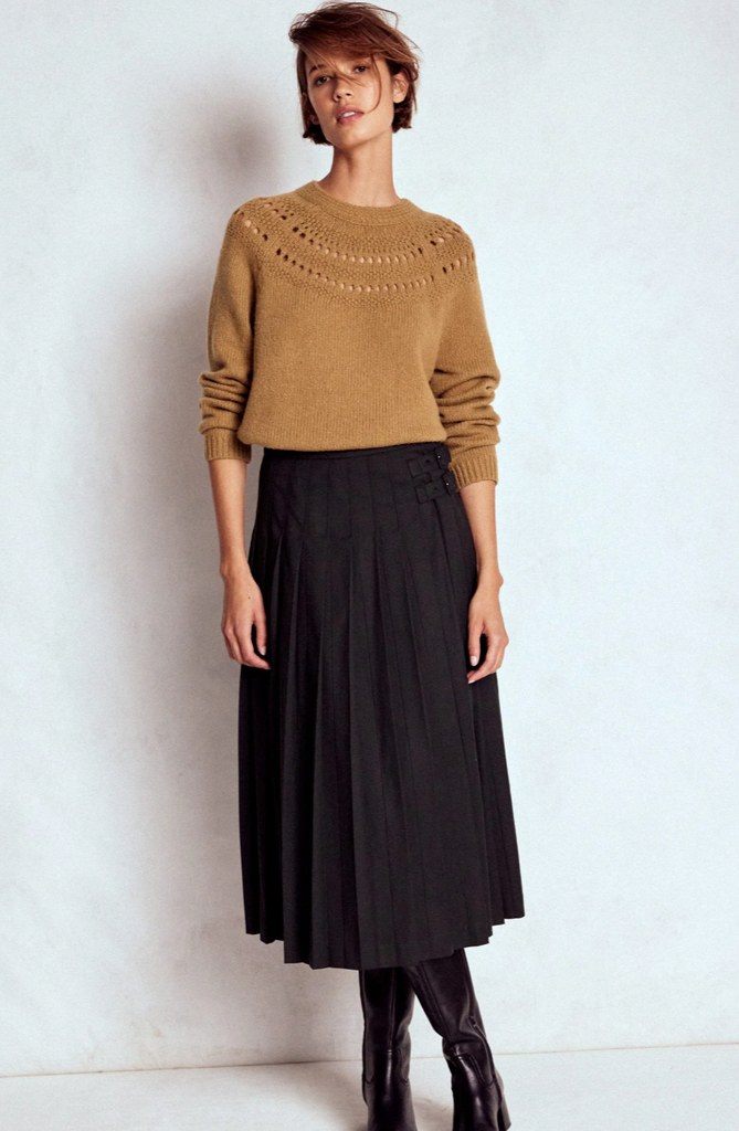 model in fluffy camel jumper and black skirt