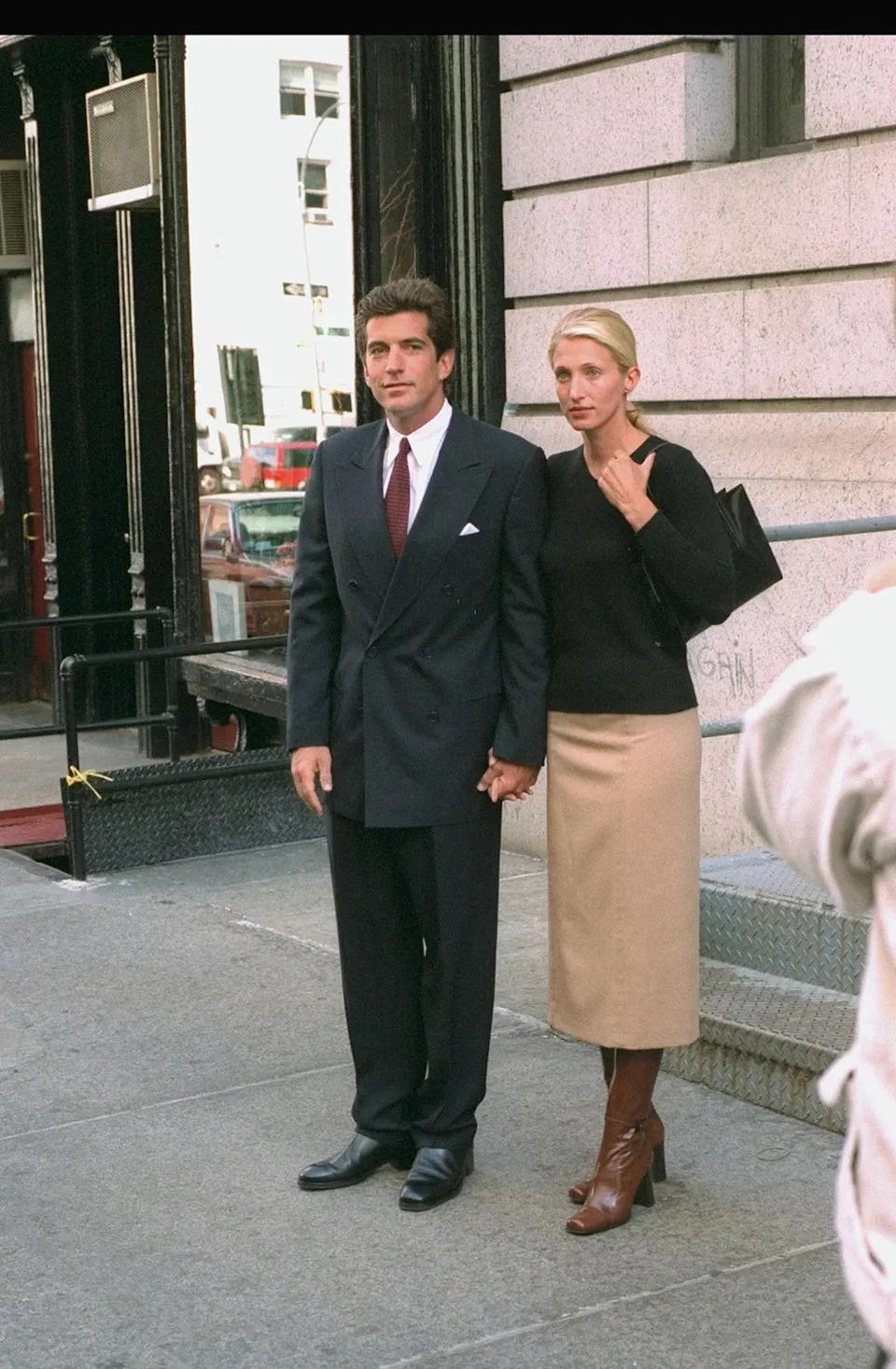 Carolyn Bessette-Kennedy walking outside with John F. Kennedy Jr.