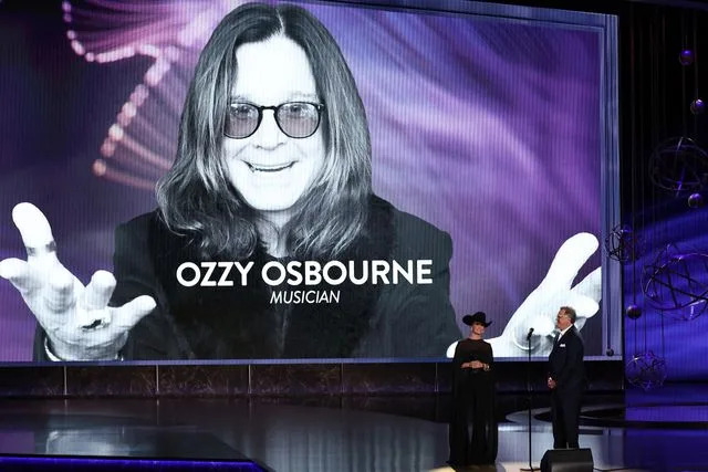 VALERIE MACON/AFP via Getty Vince Gill and Lainey Wilson perform at the 2025 Emmys