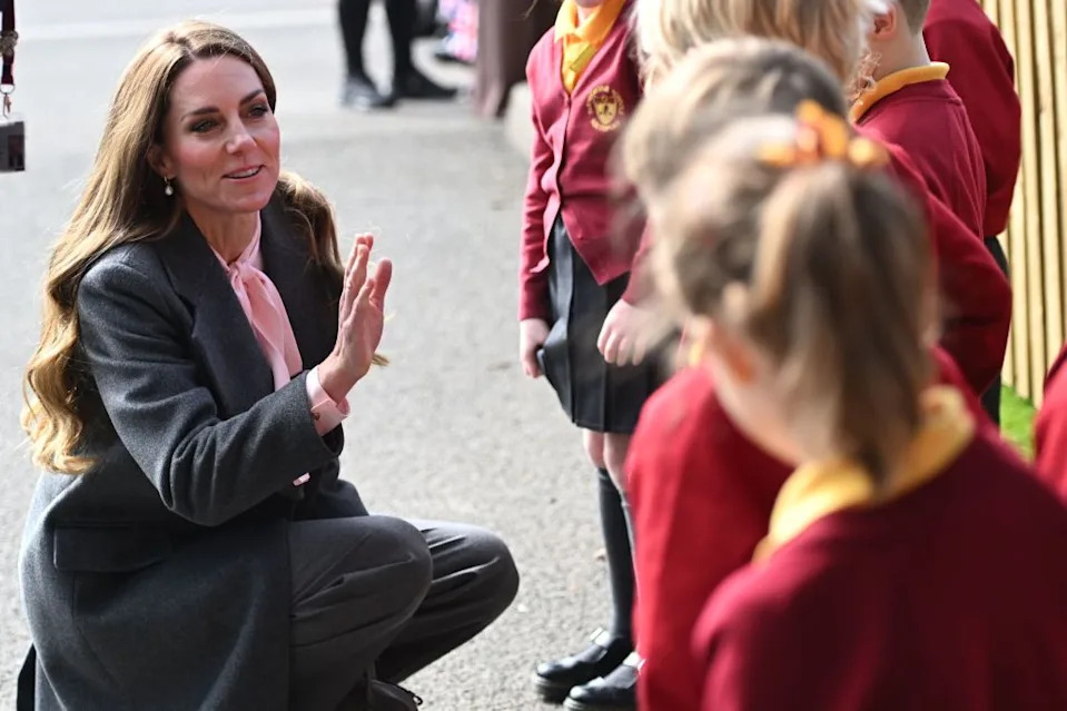 Kate Middleton talks to school children affected by the 2024 stabbing attack. Eddie Mulholland/WPA Pool/Shutterstock
