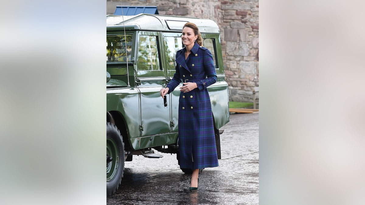 Kate Middleton smiling next to Prince Philip's van in the U.K.