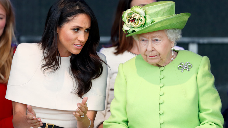 Meghan Markle speaking to Queen Elizabeth II in 2018