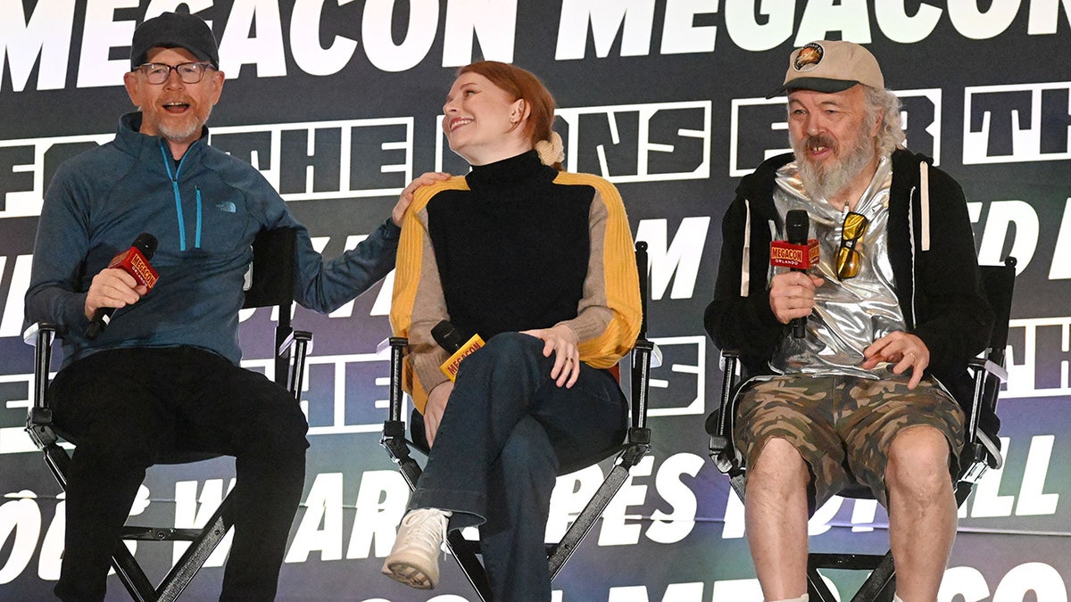 Ron, Clint and Bryce Dallas Howard speaking at an event