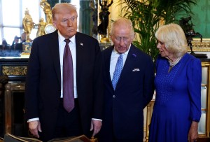 WINDSOR, ENGLAND - SEPTEMBER 17: (L-R) US President Donald Trump, King Charles III and Queen Camilla view items on display during a visit to the Royal Collection exhibition, in the Green Drawing Room during the State visit by the President of the United States of America at Windsor Castle on September 17, 2025 in Windsor, England. (Photo by Anna Moneymaker/Getty Images)