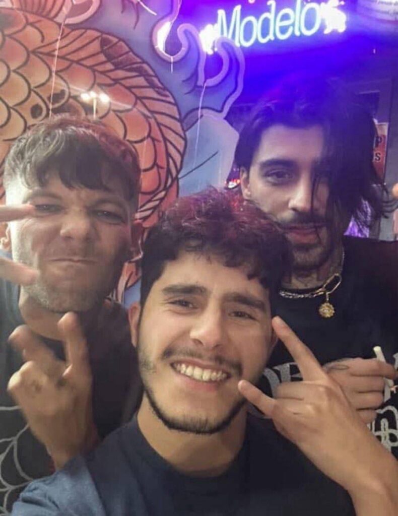 Zayn Malik and Louis Tomlinson with a fan