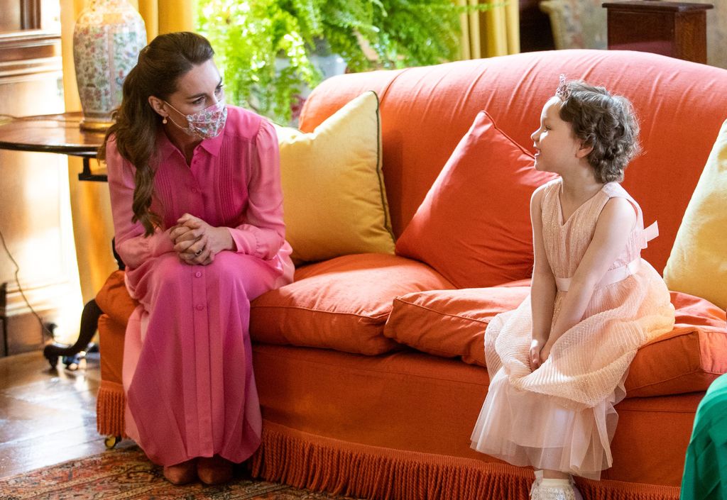 The Princess of Wales meets five year-old Mila Sneddon, a cancer patient who featured in an image from the Hold Still photography project