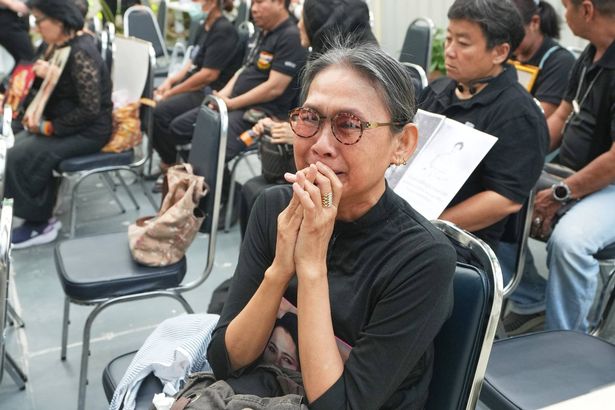 Mourners gather on the premises of Chulalongkorn Hospital in Bangkok, Thailand Saturday, Oct. 25, 2025, after hearing the news that Thailand Queen Mother Sirikit died. (AP Photo/Sakchai Lalit)