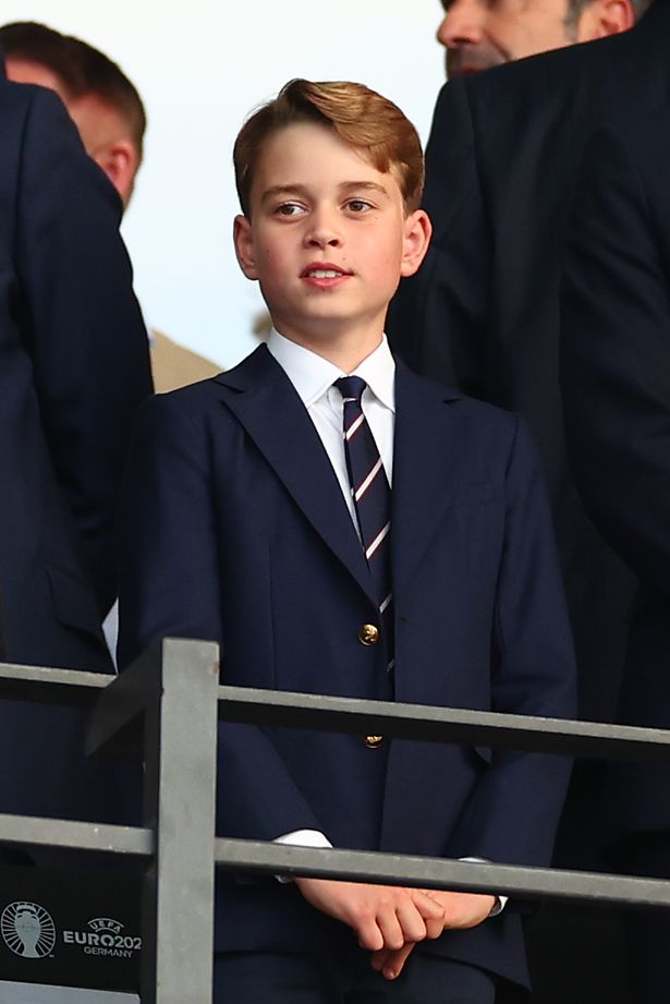 Prince George of Wales looks on prior to the UEFA EURO 2024 final match. He is wearing a suit and has his hands clasped together while slightly smiling.