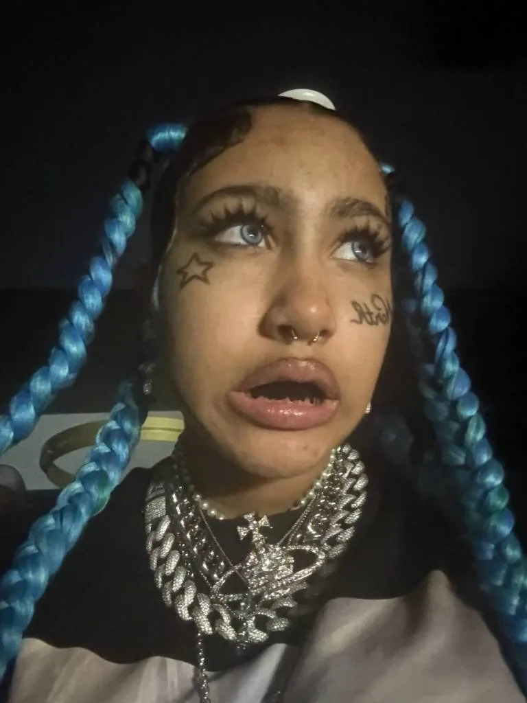 West rocked fake face tattoos, black grillz over her teeth and a faux septum ring in multiple TikTok videos she posted. kimandnorth/TikTok