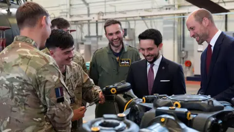 PA Media The Prince of Wales (right) and the Crown Prince Hussein of Jordan look at a main rotor head from a chinook helicopter as they meet trainee aircrew and staff from No. 28 (AC) Sqn and No. 22 Sqn during a visit to RAF Benson in Wallingford, Oxfordshire.