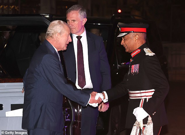Pictured: King Charles shaking the hand of a military personnel at the event