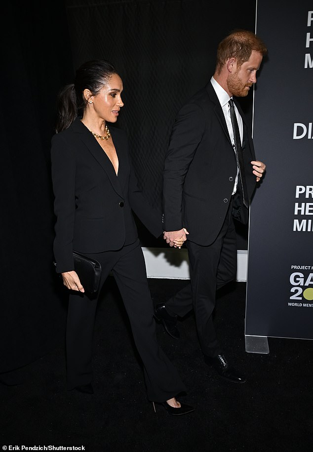 She accessorized with a black clutch, towering high heels, and a pair of diamond earrings