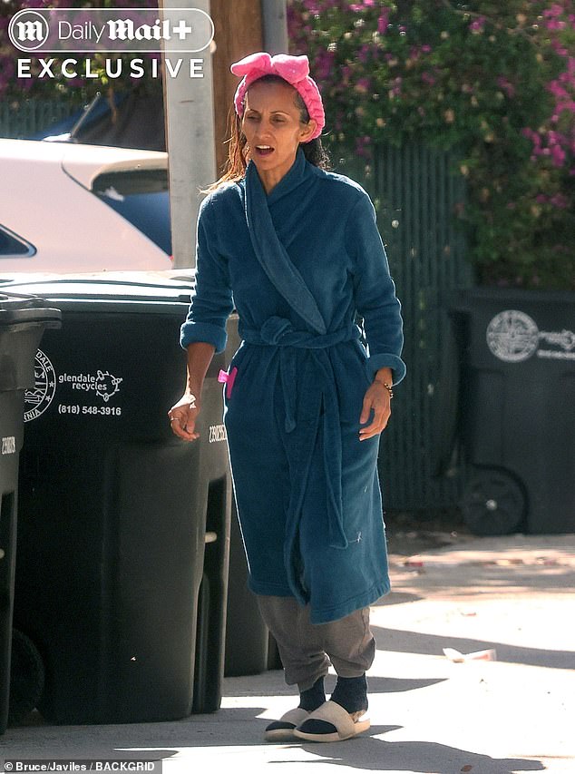 She was spotted walking towards the trash in a bath robe, slippers and a make-up headband