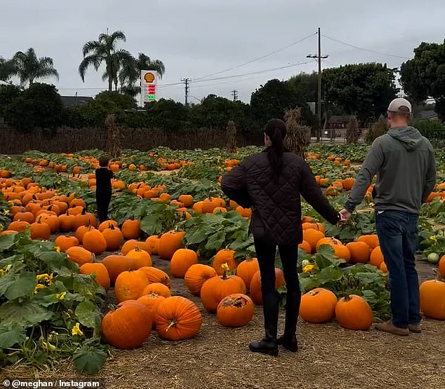 In the footage Meghan dons a pair of black knee-high boots and leggings with a black jacket while Harry opts for a casual look in jeans, a hoodie and a baseball cap. The pair can be seen holding hands