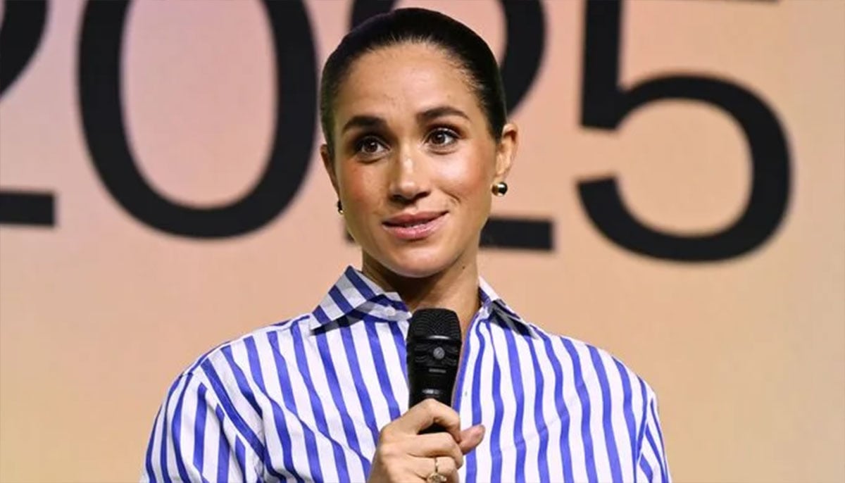 Meghan Markle in striped shirt and sleek bun