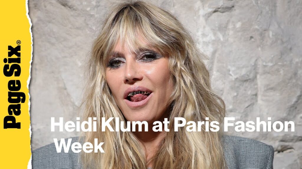 Heidi Klum pairs completely see-through lace dress with a platinum grill at Vetements show during… Heidi Klum pairs completely see-through lace dress with a platinum grill at Vetements show during...