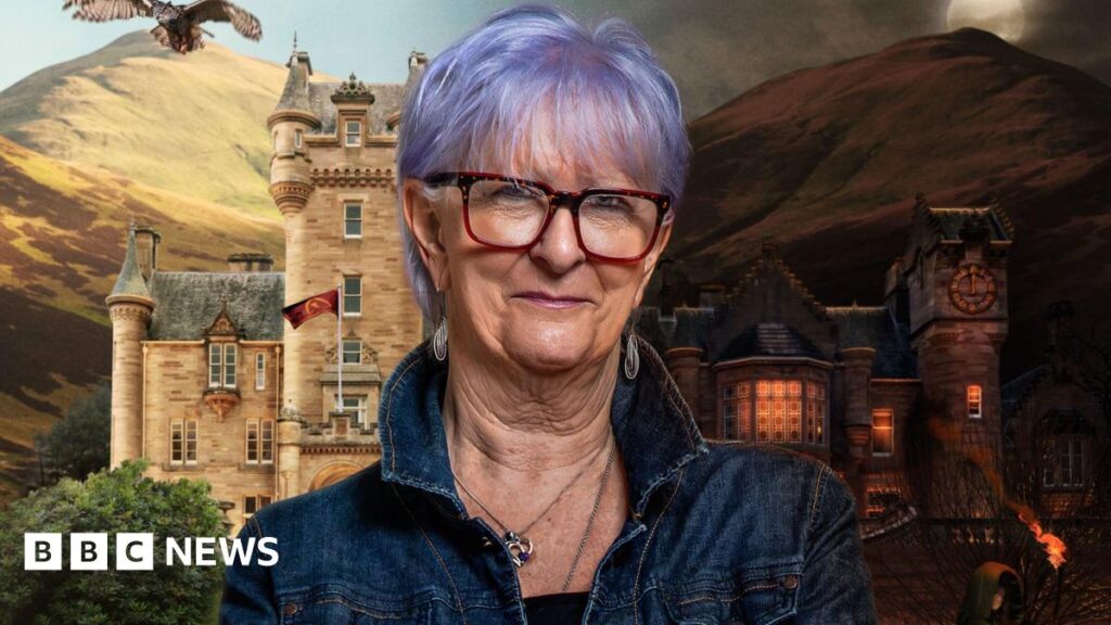 A promo shot of Linda with the Traitors castle behind her. Part of it is a daytime scene, and part is at night.