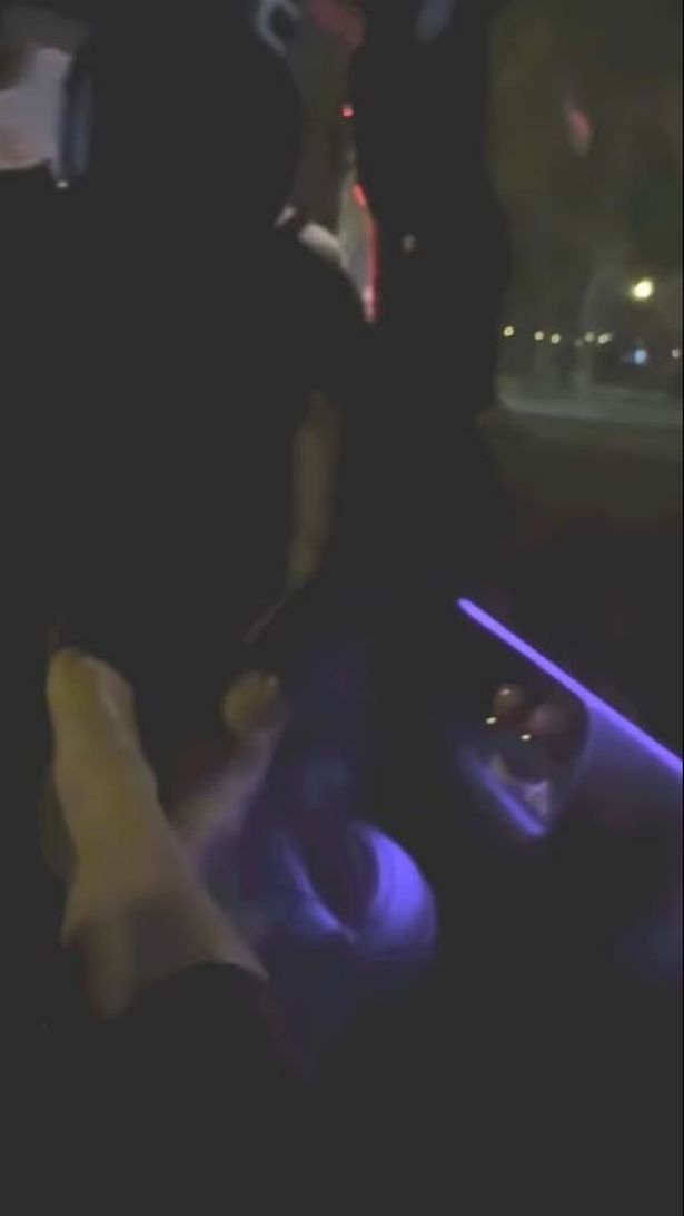 Grab of Meghan Markle's video with her feet up on a seat in the car