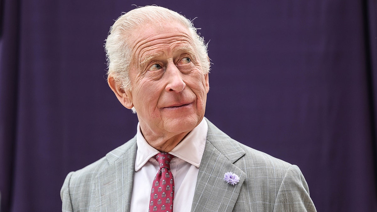 King Charles in a grey suit looking serious as he completes duties while battling cancer.