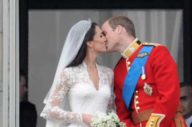 Catherine, Duchess of Cambridge and Prince William, Duke of Cambridge kiss on the balcony at Buckingham Palace on April 29, 2011 in London, England. 
