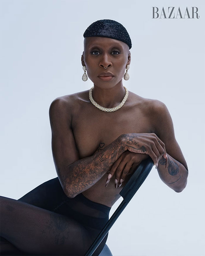 Cynthia Erivo posing topless with tattoos and jewelry in a striking and controversial Harper’s Bazaar fashion shoot.