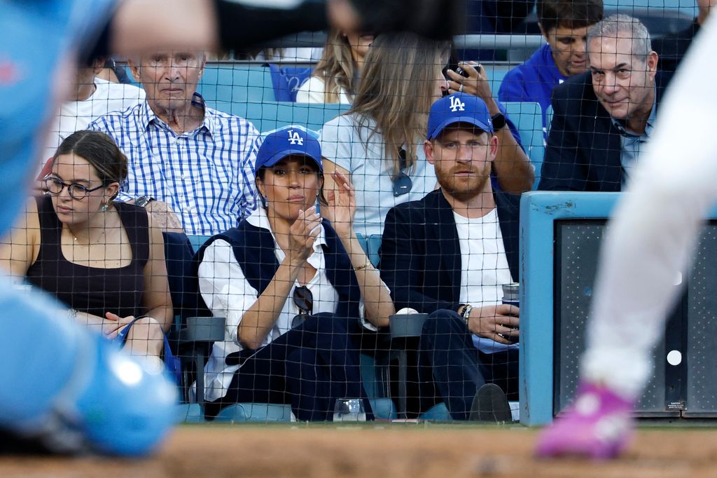 Prince Harry, Duke of Sussex and Meghan, Duchess of Sussex look on from the stands during game four of the 2025 World Series between the Toronto Blue Jays and the Los Angeles Dodgers 