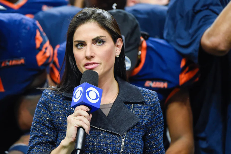 SAN ANTONIO, TX - DECEMBER 03: CBS Sports sideline reporter Jenny Dell prepares to interview UTSA Roadrunners head coach Jeff Traylor following the football game between the Western Kentucky Hilltoppers and UTSA Roadrunners at the Alamodome on December 3, 2021 in San Antonio, Texas. (Photo by Ken Murray/Icon Sportswire via Getty Images)Icon Sportswire/Getty Images