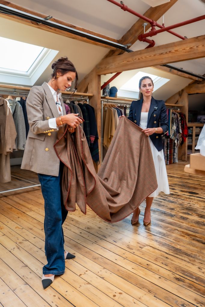 Two woman looking at a piece of fabric