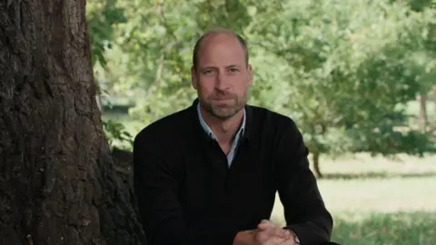 Kensington Palace/PA Wire Prince William sits at the foot of a tree looking out beyond the shot of the camera.