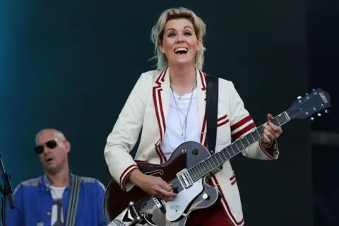 EPA Brandi Carlile beams as she plays the Pyramid Stage at the 2025 Glastonbury Festival