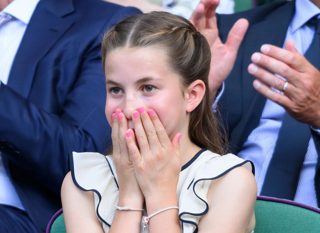 A photo of a young girl with pink nails 