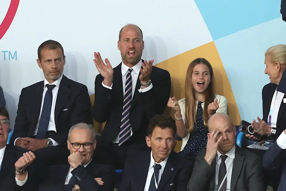 Prince William wears a suit with a red, white, and blue striped tie, and daughter Princess Charlotte wears a navy and white polka dot dress, as the pair attend the UEFA Women's Championship in Switzerland