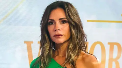 Bauer-Griffin/GC Images/Getty Images Victoria Beckham in a green dress