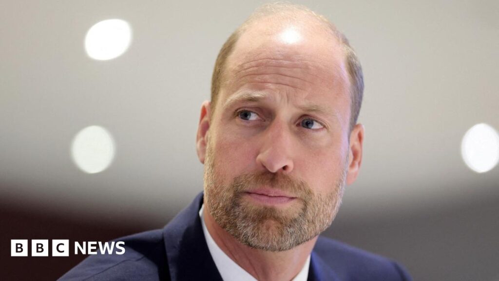 Close up shot of Prince William  in a navy suit