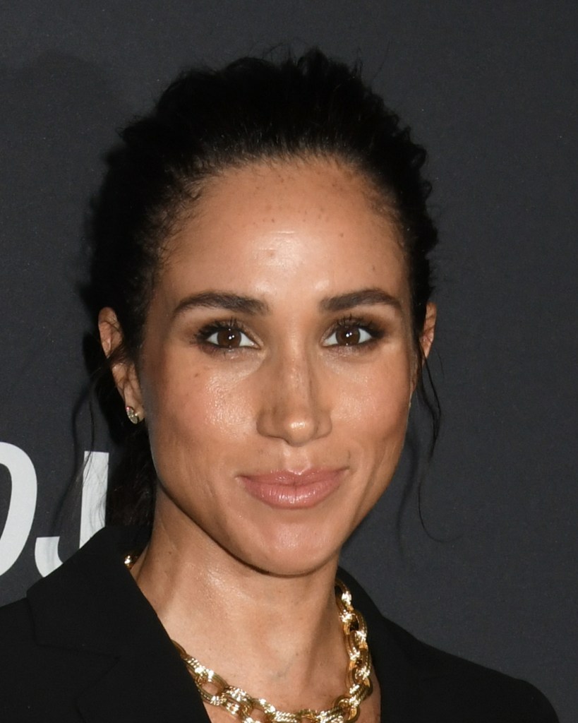 Meghan Markle smiling on the red carpet