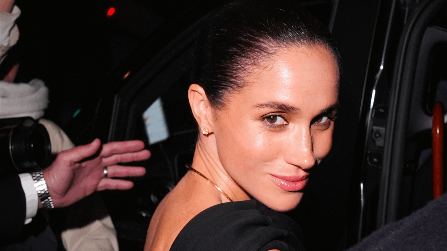 Meghan Markle Is Trolled for Paris Video Because the Internet Is The Worst, Yet Again Meghan Markle wearing a black dress