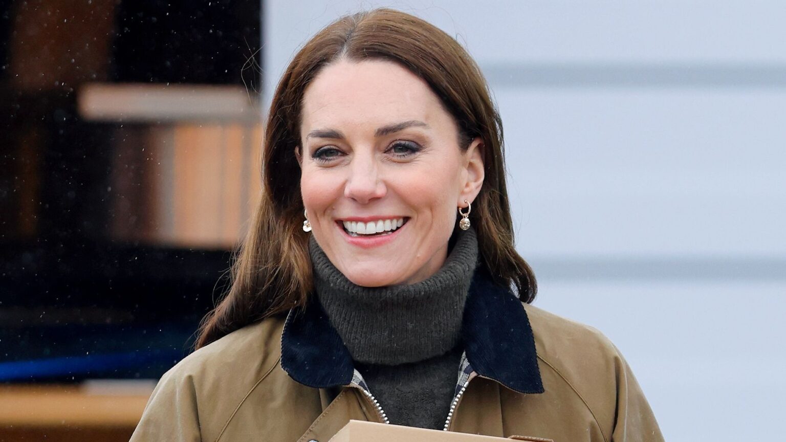 Catherine, Princes of Wales carries takeaway pizza boxes, collected from a pizza van, as she visits Dowlais Rugby Club on April 27, 2023