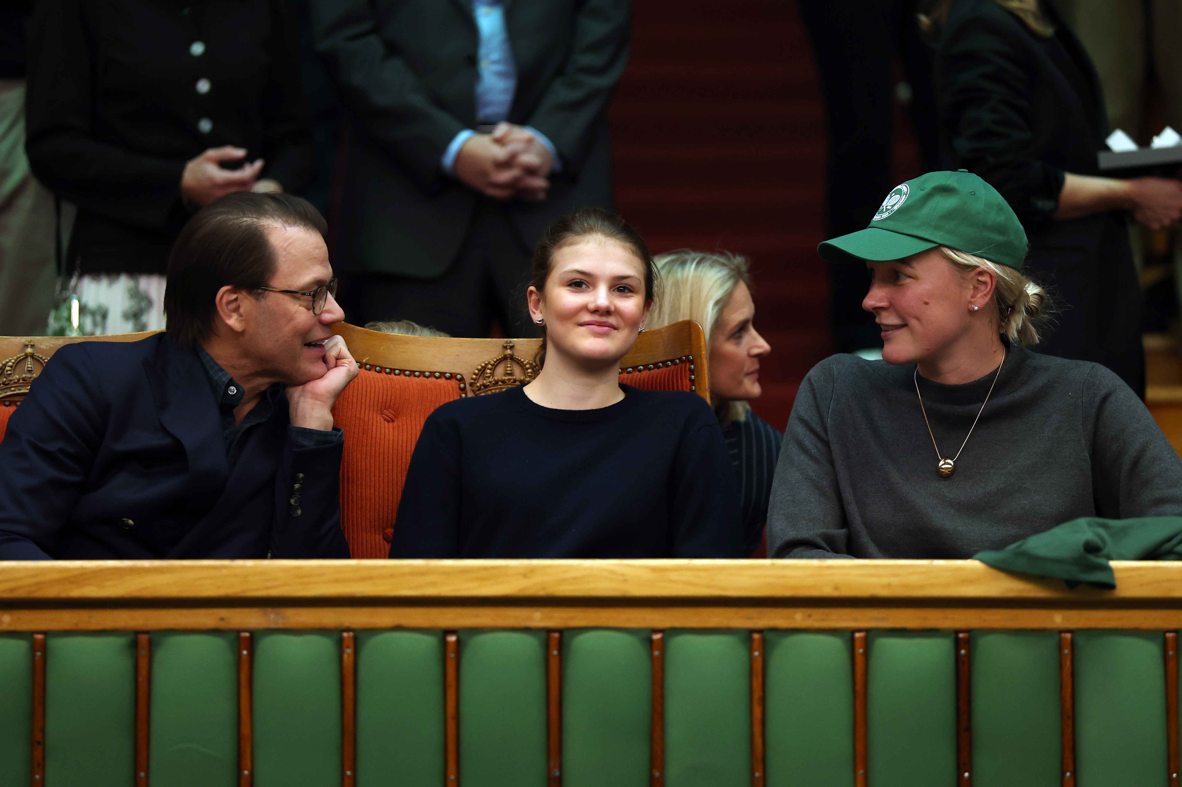 Prince Daniel turning to talk to swimmer Sarah Sarah Sj&ouml;str&ouml;m while watching a tennis match with Princess Estelle