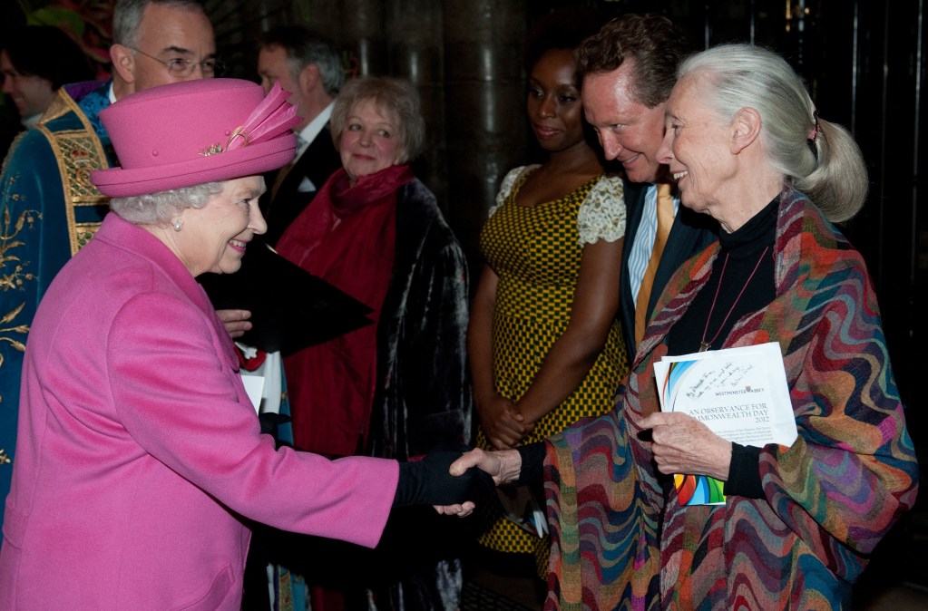 Britain's Queen Elizabeth II (L) shakes hands with conservationist Dr Jane Goodall (R)