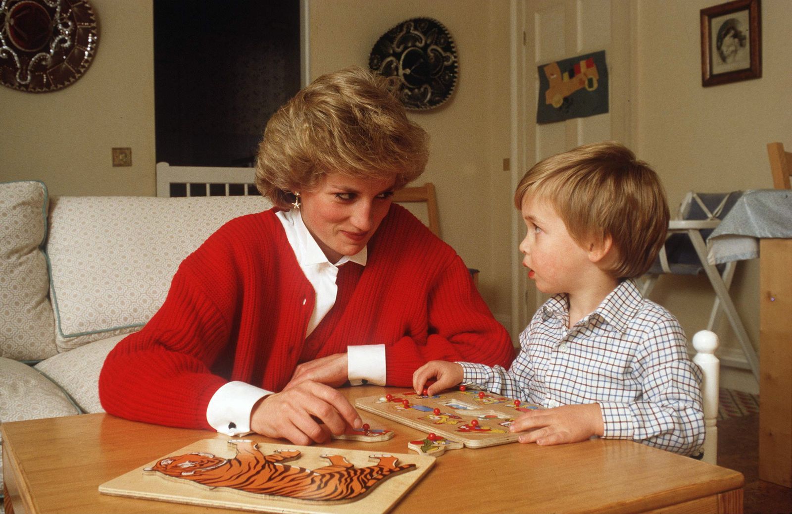 Where Did Princess Diana Live A Peek Into the Icons Royal Residences Princess Diana in red sweater puts together puzzles...