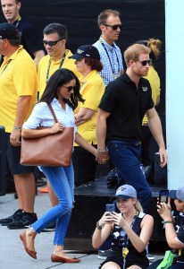 TORONTO, ON - SEPTEMBER 25:  Prince Harry (R) and Meghan Markle (L) hold hands a Wheelchair Tennis match during the Invictus Games 2017 at Nathan Philips Square on September 25, 2017 in Toronto, Canada.  (Photo by Vaughn Ridley/Getty Images for the Invictus Games Foundation)