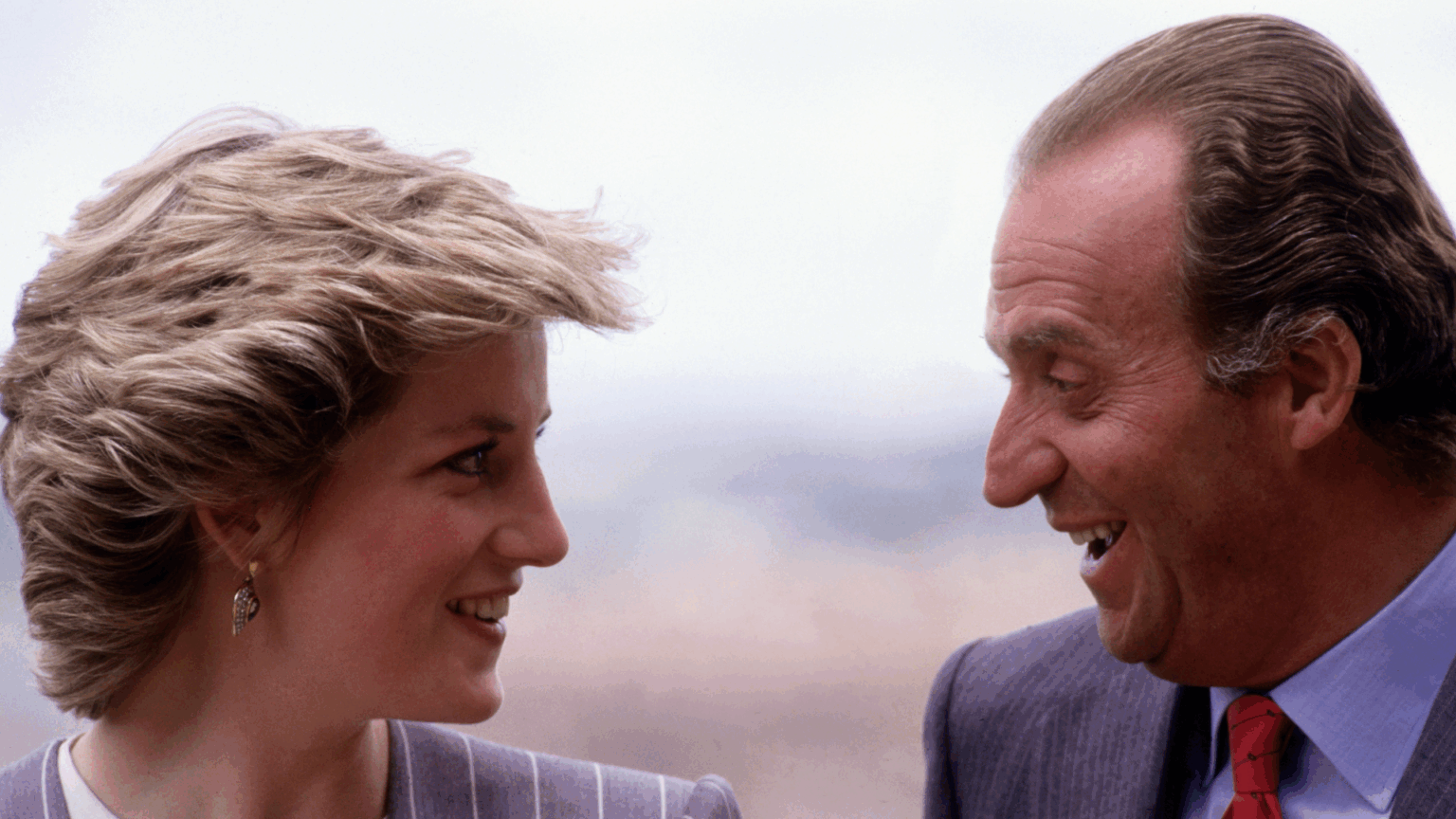 The Former King of Spain Addresses Princess Diana Affair Rumor in New Memoir Princess Diana and King Juan Carlos facing each other smiling
