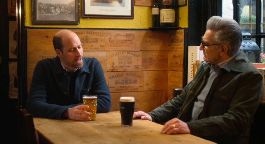 Prince William sharing a pint with Eugene Levy on The Reluctant Traveller