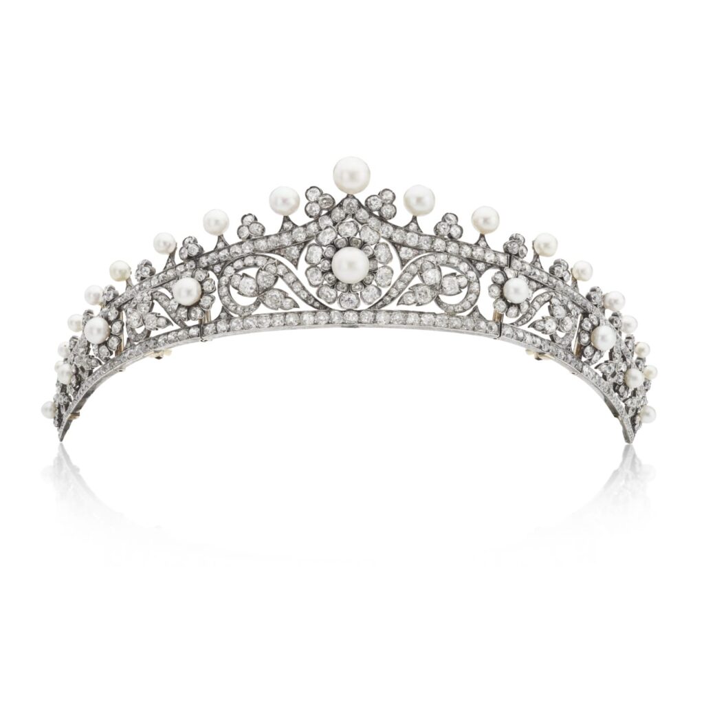 Elegant silver tiara adorned with pearls and diamonds against a white background.