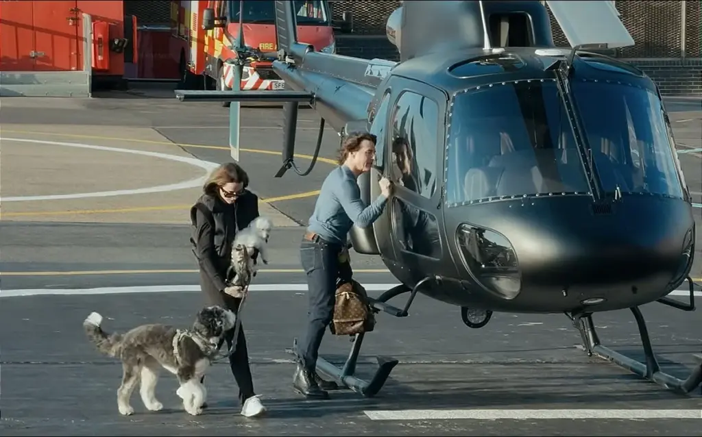 Tom Cruise lands a black Airbus helicopter like a pro with Ana de Armas riding as a passenger