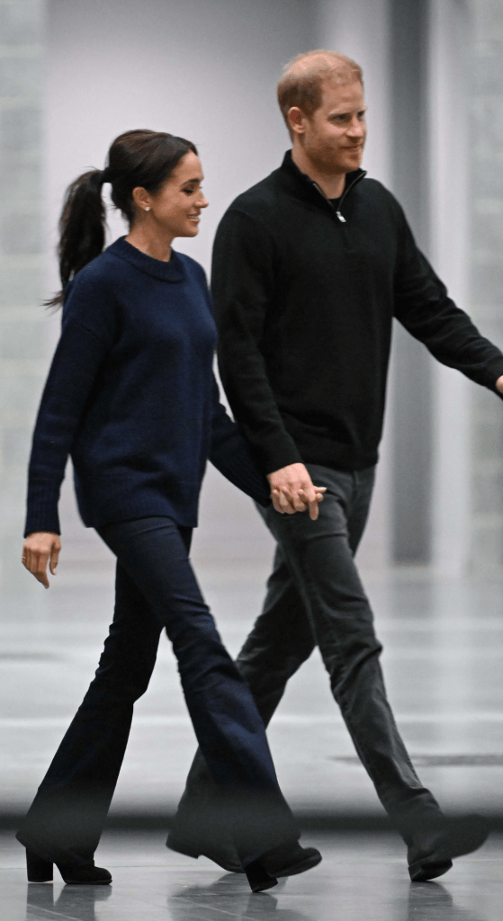 Prince Harry and Meghan Markle holding hands