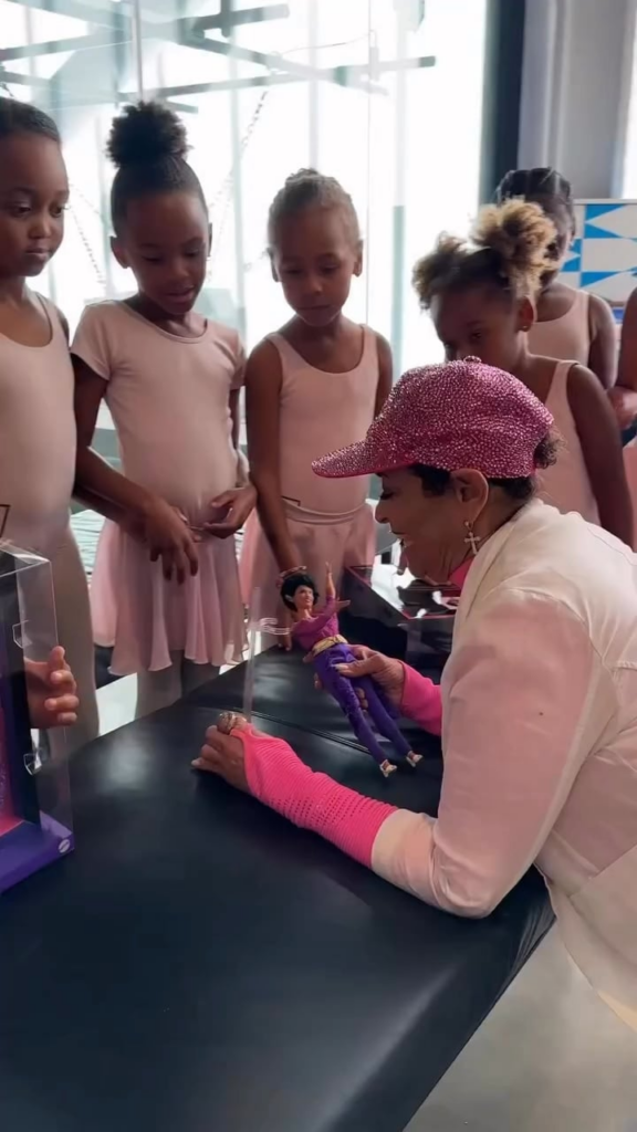 Debbie Allen shows off her recently released Barbie doll to her dance students, part of the Barbie Tribute Collection